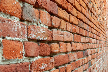 Red Brick Wall With Diminishing Perspective. Fragment of brown brick wall with a shallow depth of field. Angled View Looking Down a Brick Alleyway