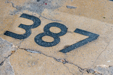 terrazzo floor with the numbers 3 8 and 7 in green on sand yellow - retro design 