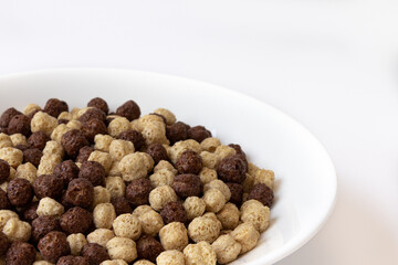 chocolate cereal in bowl isolated on white background