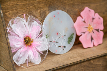 The pink coasters is made of epoxy resin. Stand, tray, or decorative element on wooden shelf.