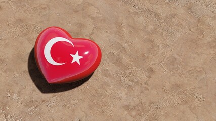 Heart with Turkish flag on the sand beach