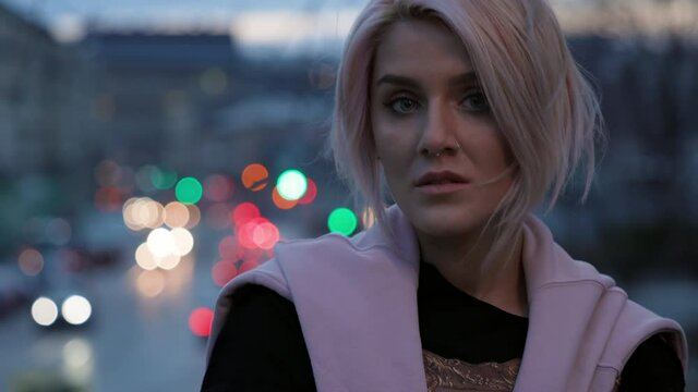 Girl With Pink Hair. Portrait Of Young Girl With Pierced Nose. Wind Blows Her Hair. Evening City.