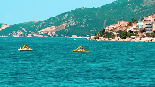 Tourists bathing at sea during hot summer day in Neum, Bosnia and Herzegovina.
