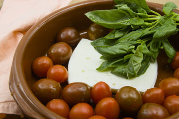 Oven casserole with cheese, cherry tomatoes and basil