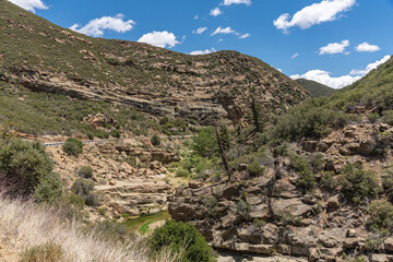 Los Padres National Forest, CA, USA - April 8, 2010: Mountain flank scenery above Matiliija Creek valley landscape. Plenty of green vegetation at bottom. Road 33 cuts through.