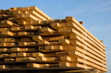 a stack of wooden planks building materials