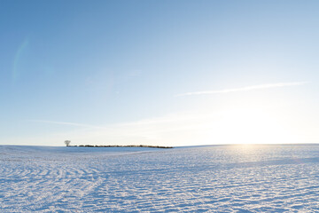 A sunny snowy landscape in rural countryside in winter