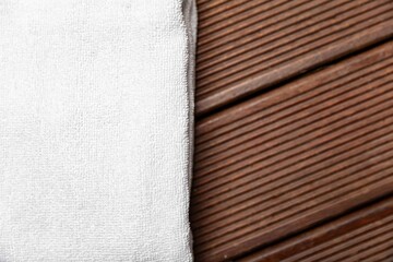 Clean white towels folded on a brown wood table.