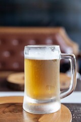 A large beer mug is placed on the counter table inside the bar.