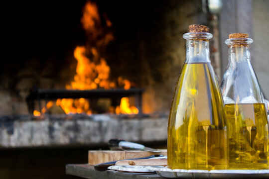 Olive oil bottle and fire and grill