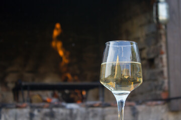 Glass of white wine and fire