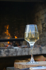Glass of white wine and fire