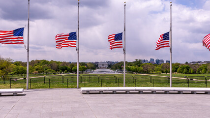 Panoramic view at Lincoln memorial behind the US flags from the ground of Washington monument.