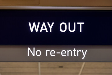 Posted sign above the hallway read "WAY OUT" and "no re-entry"