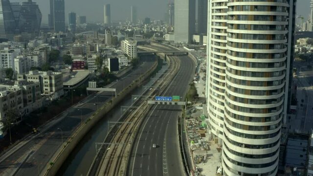 Aerial Shot Of Highways By Modern Building On Sunny Day, Drone Flying Over Roads During Lockdown - Tel Aviv, Israel