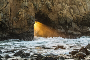 light & water crashing through rocks