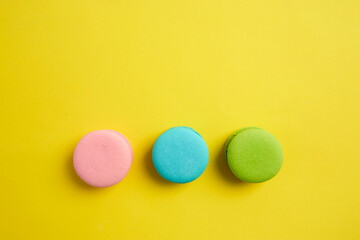 French macaroon biscuits on colorful background