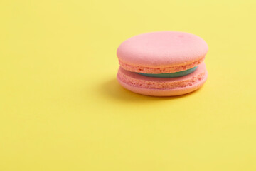Pink macaroons on bright yellow background
