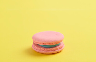 Pink macaroons on bright yellow background