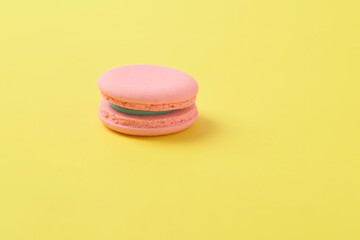 Pink macaroons on bright yellow background