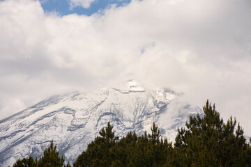 Volcano with snow, fog and sun
