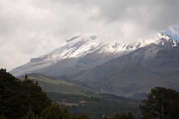 Fototapeta premium Volcano with snow, fog and sun