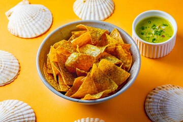 green queso and tortilla on table