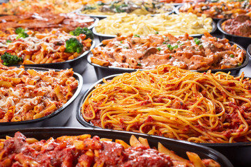 A view of several varieties of pasta trays, featuring a tray of spaghetti.