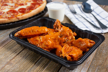 A view of a container of buffalo wings.