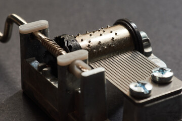 Small clockwork music box close up, vintage musical instrument