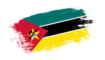 Flag of Mozambique country on brush paint stroke trail view. Elegant texture of national country flag