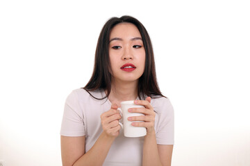 Beautiful young south east Asian woman holding white coffee tea cup emotion expression on white background look