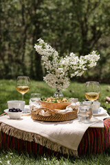 Al fresco dinning in backyard with pasta and drinks in lush green surrounding