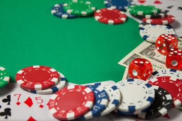 Classic playing cards, chips, red dice and dollars on green background. Gambling and casino concept.
