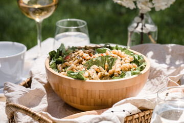 Al fresco dinning in backyard with pasta and drinks in lush green surrounding