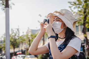 Traveler, travel young asian woman or girl use camera take photo, old town street, city tourism on happy sunny day..Backpacker tourist, holiday trip, summer or vacation, hobby concept.