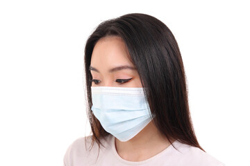 Beautiful young south east Asian woman wearing blue three ply anti virus surgical face mask on white background look down