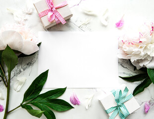 Pink peonies with empty  card and  gift box on  white  background