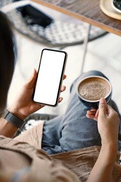 woman holding smart phone showing white screen at morning