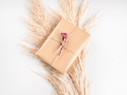 Gift Box Wrapped In Craft Paper With Dried Flowers