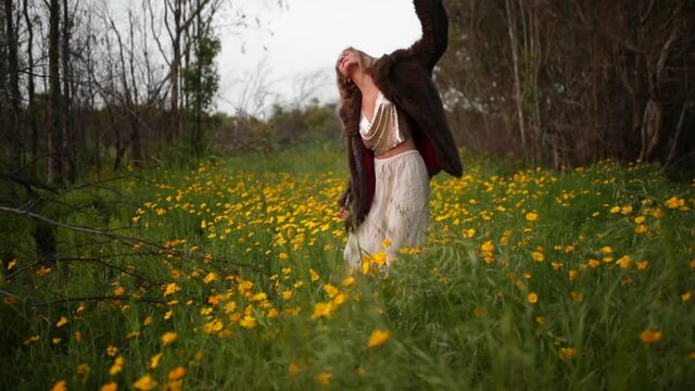 Slow Motion Shot Of Smiling Woman Dancing In Filed Of Flowers During Vacation - Negev, Israel
