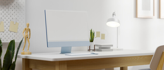 Blue pastel computer monitor with mock-up screen on white table in simple home office, 3D rendering