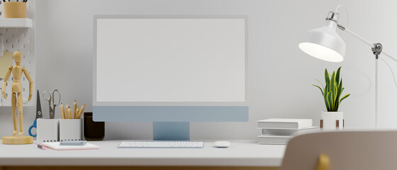 Blue pastel computer monitor with mock-up screen on table with stationery, lamp and decorations, 3D rendering