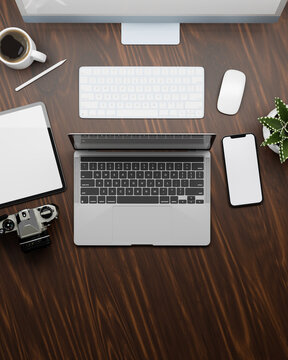 Top view of working space with laptop, computer, tablet smartphone and supplies on wooden table, 3D rendering