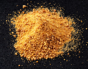pile of granulated coconut blossom sugar on black