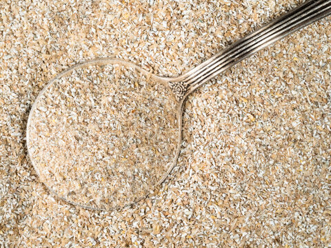 top view of silver tablespoon in rye bran