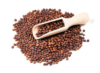 wooden scoop on pile of dried red Kampot pepper