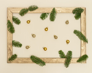 Christmas background with retro wooden frame with green fir branches and golden christmas balls