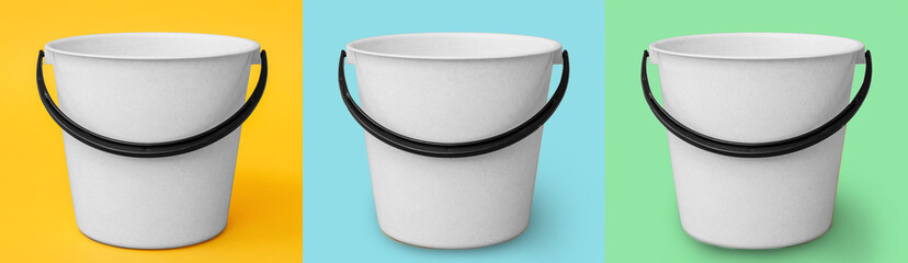 Plastic buckets on color background