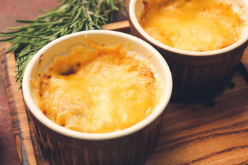 Ramekins with tasty julienne on table, closeup